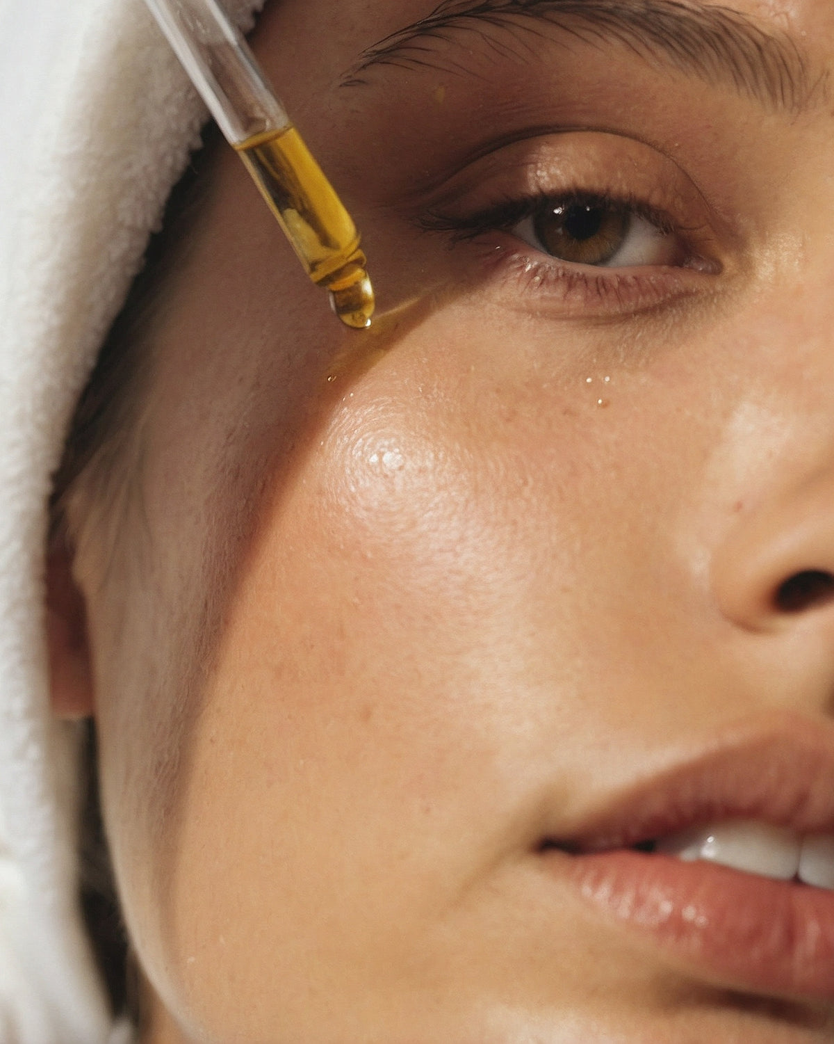 Application d’un soin huileux sur le visage dans une routine naturelle